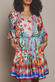 Model Ziara wearing size S of the Carlisle Dress in colour Print, from the front, cropped image