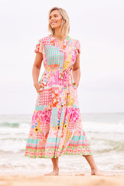 Model Phoebe wearing size S of the Costa Rica Midi Dress in colour Sea (Pink), from the front, showing the whole outfit