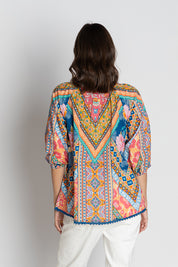 A model wearing the Danai Cotton Top in colour Ocean, from the back