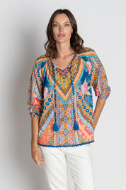 A model wearing the Danai Cotton Top in colour Ocean, from the front, cropped image