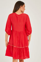 Model Georgia wearing size S of the Delilah Dress in colour Melon (Pink), from the back