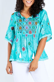 Model Pamela wearing size S of the Dixie Top in colour Sea (Green), from the front, cropped image