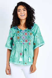 Model Pamela wearing size S of the Dixie Top in colour Sea (Green), from the front, cropped image