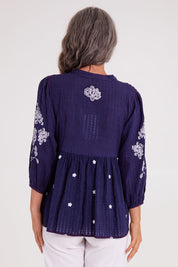 Model Luisa wearing size S of the Drew Top in colour Navy (Blue), from the back