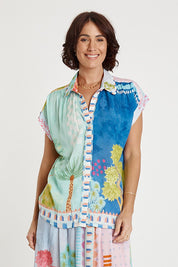 A model wearing the Etereo Top in colour Lagoon (Blue), from the front, cropped image