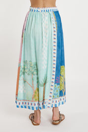 A model wearing the Etereo Skirt in colour Lagoon (Blue), from the back