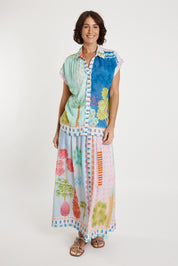 A model wearing the Etereo Skirt in colour Lagoon (Blue), from the front, showing the whole outfit