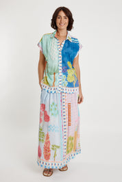 A model wearing the Etereo Skirt in colour Lagoon (Blue), from the front, showing the whole outfit