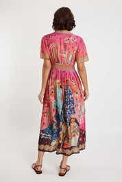 A model wearing the Fiesta Modal Blend Dress in colour Print (Pink), from the back
