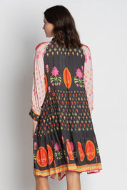 A model wearing the Grenadine Dress in colour Truffle, from the back