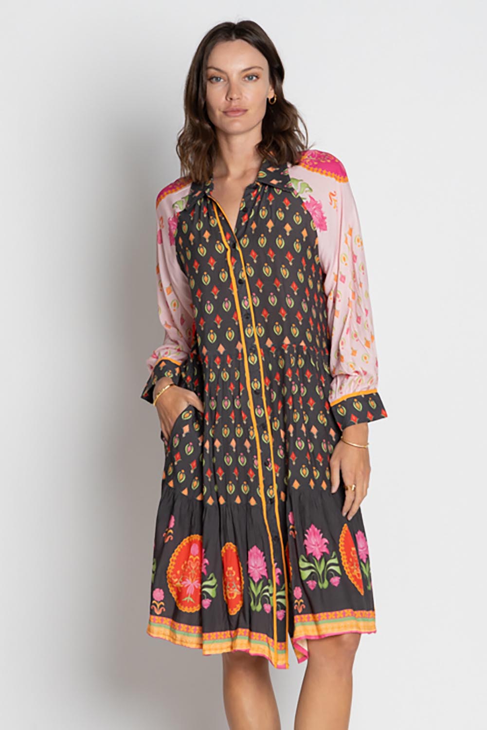 A model wearing the Grenadine Dress in colour Truffle, from the front, cropped image
