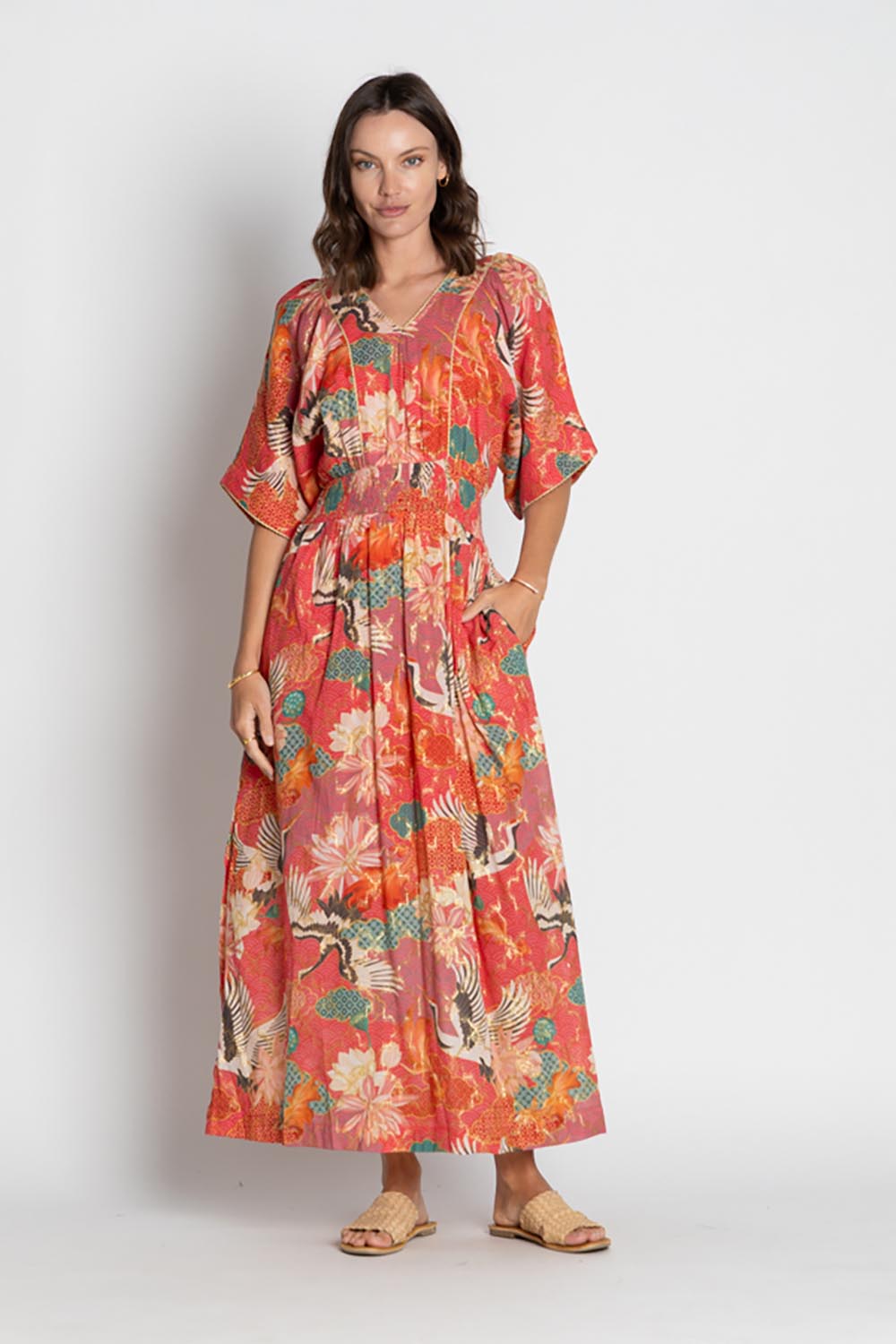 A model wearing the Hoshino Maxi in colour Pink, from the front, showing the whole outfit