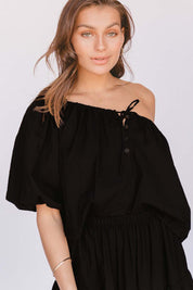 A model wearing the Kaira Top in colour Jett (Black)