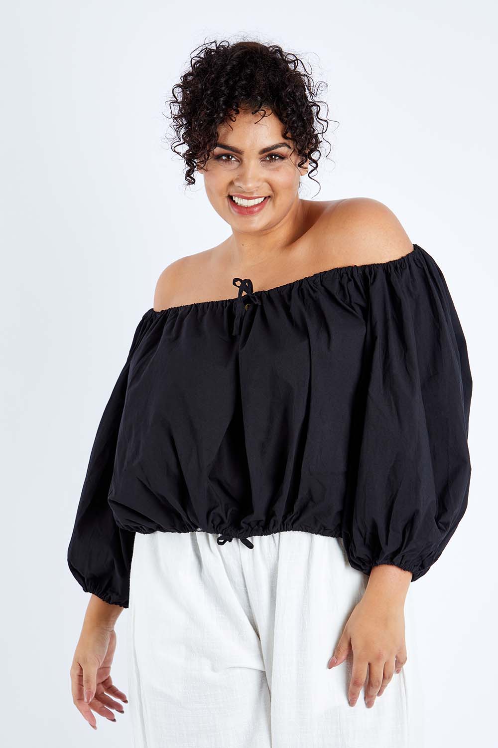 Model Sasha-Lee wearing the Kaira Top in colour Jett (Black), from the front, cropped image