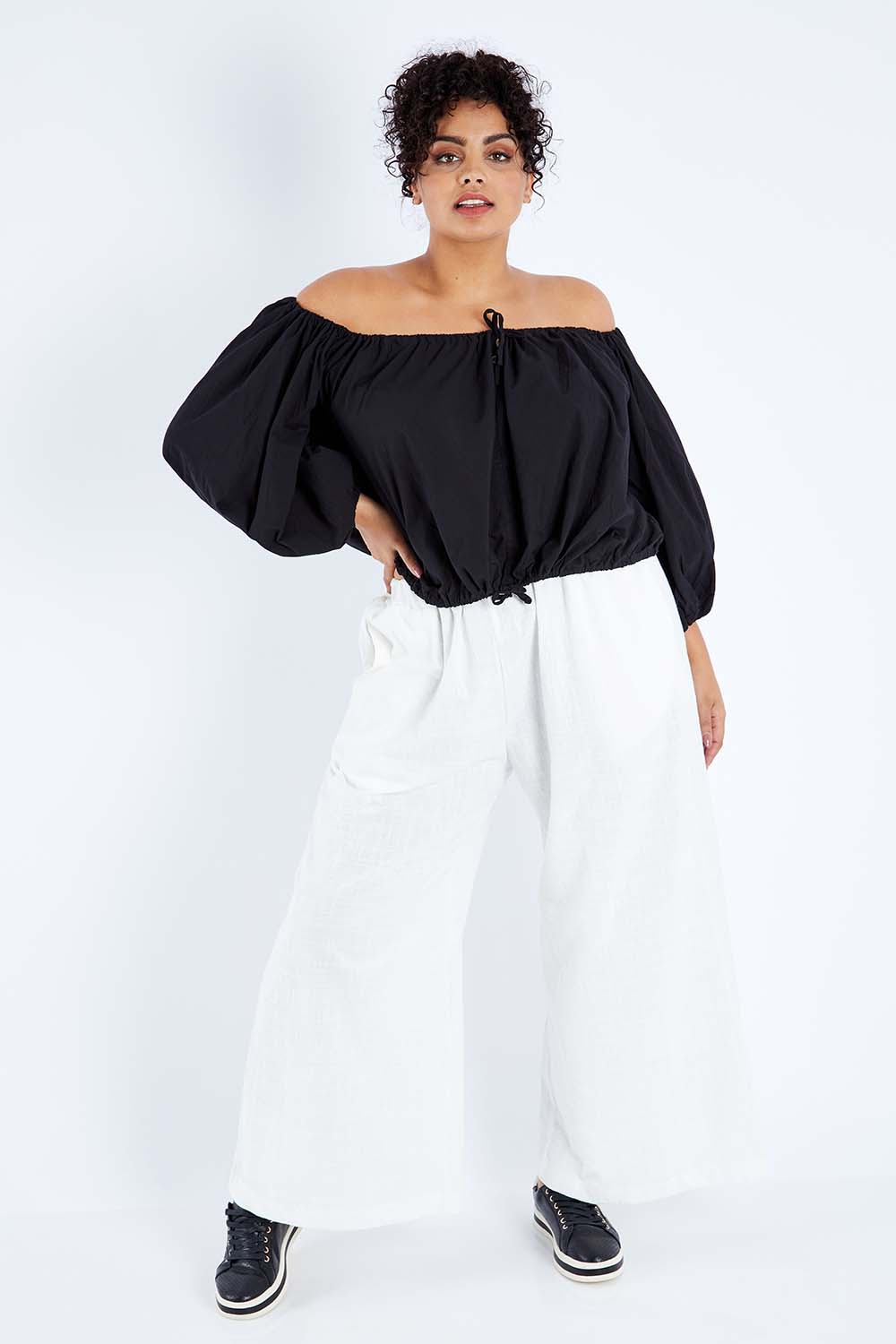 Model Sasha-Lee wearing the Kaira Top in colour Jett (Black), from the front, showing the whole outfit
