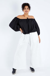 Model Sasha-Lee wearing the Kaira Top in colour Jett (Black), from the front, showing the whole outfit