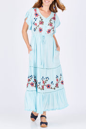 Model Katie wearing size S of the Kyoto Dress in colour Mint (Blue), from the front, cropped image