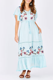 Model Laura wearing size M of the Kyoto Dress in colour Mint (Blue), from the front, cropped image