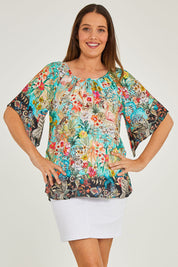 Model Georgia wearing size S of the Larisa Top in colour Mist (Blue), from the front, cropped image