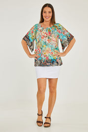 Model Georgia wearing size S of the Larisa Top in colour Mist (Blue), from the front, showing the whole outfit
