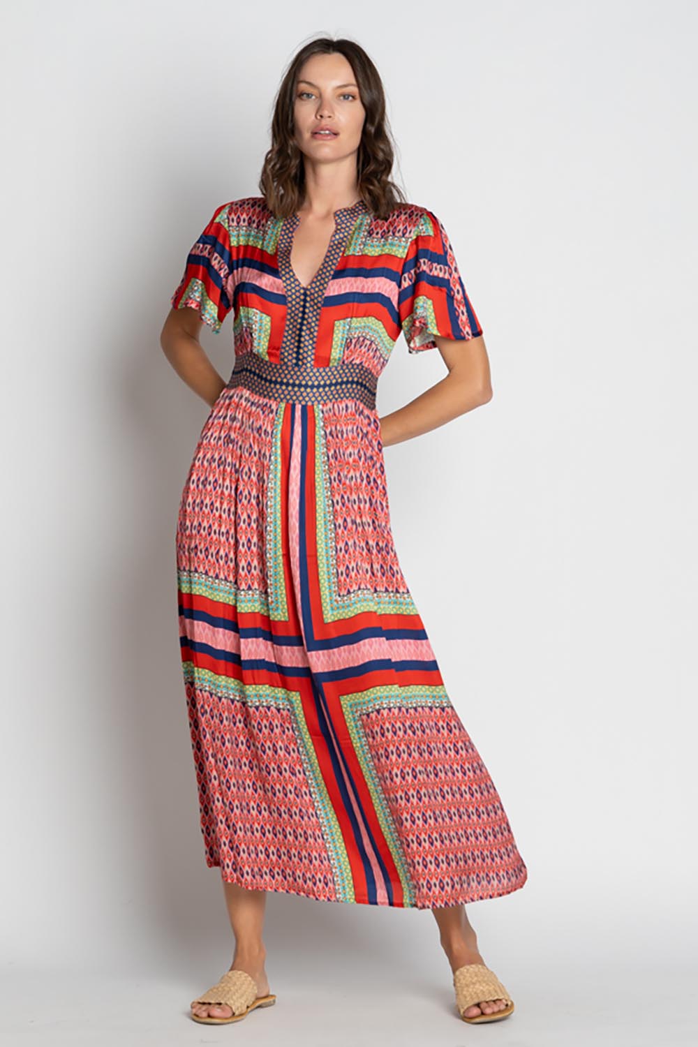 A model wearing the Legian Midi in colour Melon, from the front, showing the whole outfit