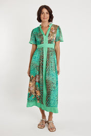 A model wearing the Maasai Midi Dress in colour Emerald (Green), from the front, showing the whole outfit