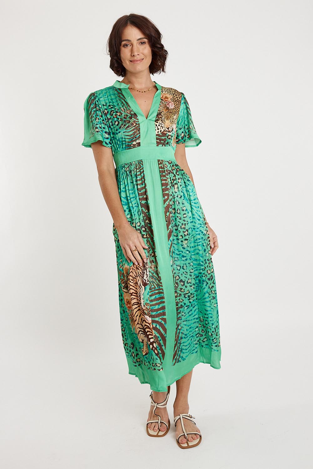 A model wearing the Maasai Midi Dress in colour Emerald (Green), from the front, showing the whole outfit