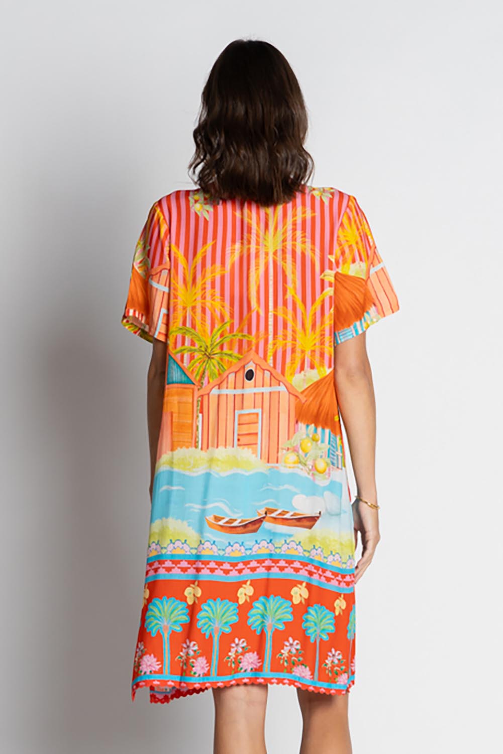 A model wearing the Mardiva Shift Dress in colour Melon, from the back