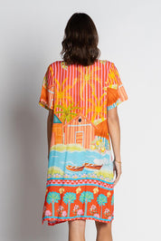 A model wearing the Mardiva Shift Dress in colour Melon, from the back