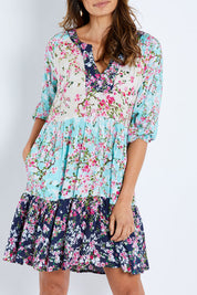 Model Amanda wearing size S of the Myoshi Dress in colour Multi (Blue), from the front, cropped image