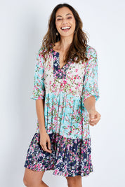 Model Amanda wearing size S of the Myoshi Dress in colour Multi (Blue), from the front, cropped image