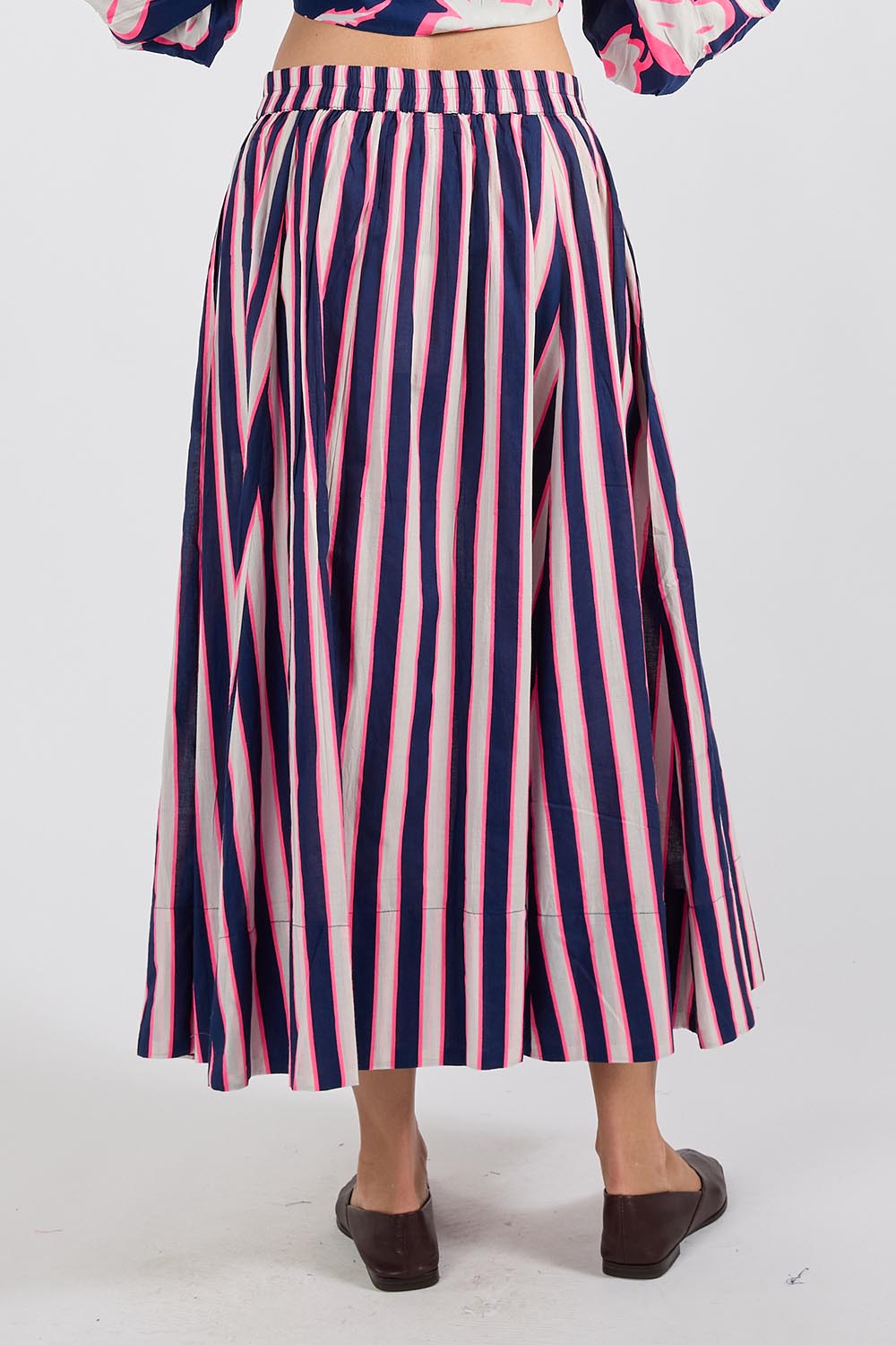 Model Genericm wearing size sample of the Palmilla Stripe Skirt – Navy in colour Navy, from the back