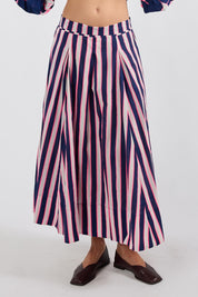 Model Genericm wearing size sample of the Palmilla Stripe Skirt – Navy in colour Navy, in a cropped view