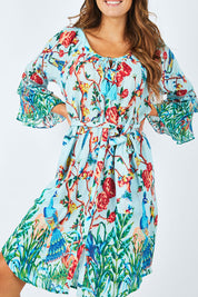 Model Madeline wearing size S of the Peacock Dress in colour Mint (Blue), from the front, cropped image