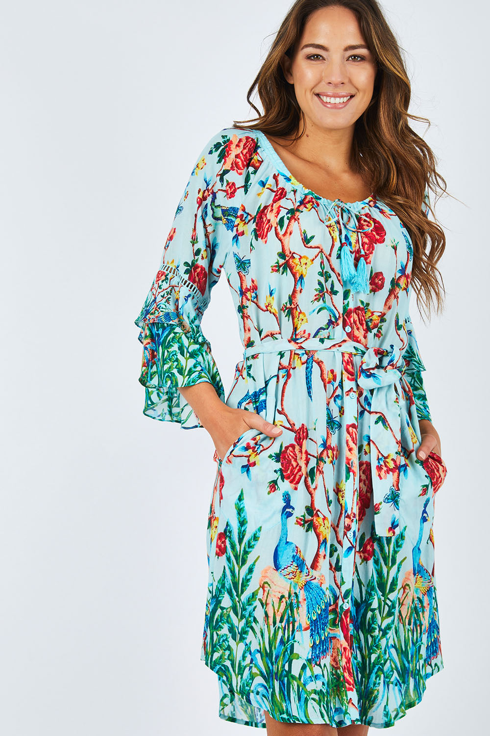 Model Madeline wearing size S of the Peacock Dress in colour Mint (Blue), from the front, cropped image