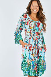 Model Madeline wearing size S of the Peacock Dress in colour Mint (Blue), from the front, cropped image