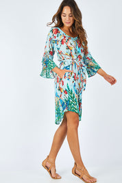 Model Madeline wearing size S of the Peacock Dress in colour Mint (Blue), from the front, showing the whole outfit