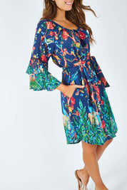 Model Madeline wearing size S of the Peacock Dress in colour Navy (Blue), from the front, cropped image