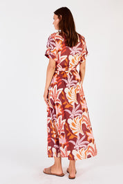 A model wearing the Portabella Midi Dress in colour Sienna, from the back