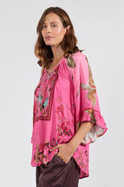 Model Genericm wearing size sample of the Sachiko Top – Fuchsia in colour Fuchsia, from an angle