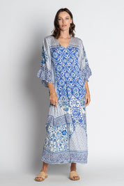A model wearing the Sensiri Midi Dress in colour Navy (Blue), from the front, showing the whole outfit