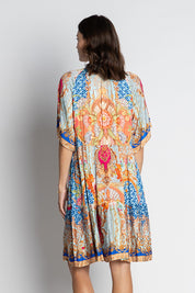 A model wearing the Le Sereno Dress in colour Ocean, from the back