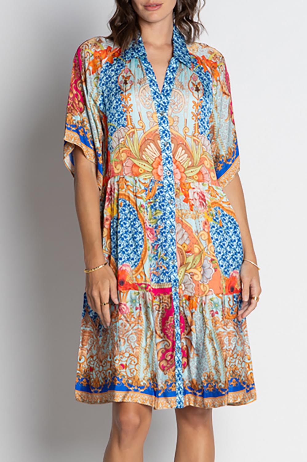 A model wearing the Le Sereno Dress in colour Ocean, from the front, cropped image