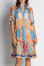 A model wearing the Le Sereno Dress in colour Ocean, from the front, cropped image