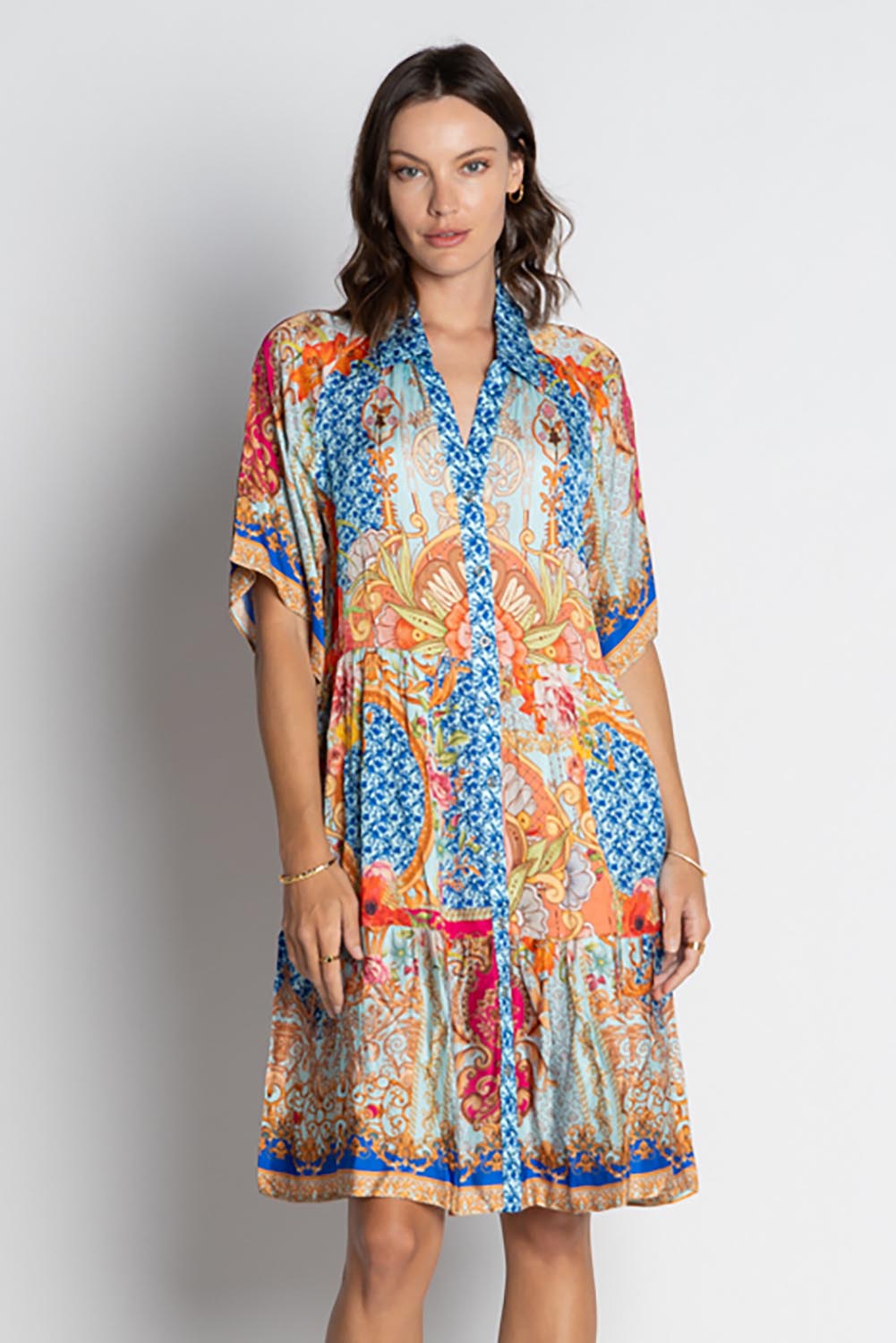 A model wearing the Le Sereno Dress in colour Ocean, from the front, cropped image