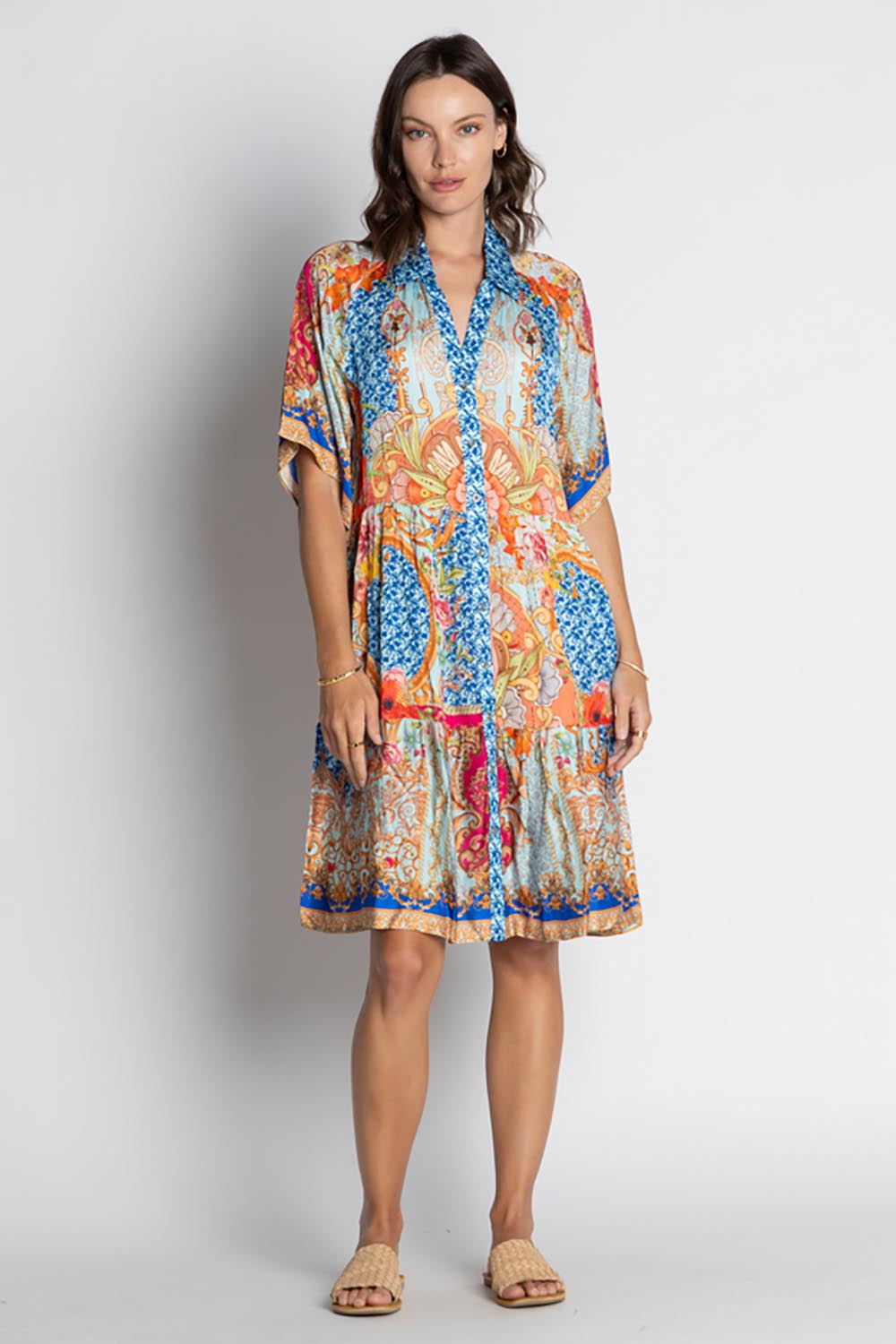 A model wearing the Le Sereno Dress in colour Ocean, from the front, showing the whole outfit