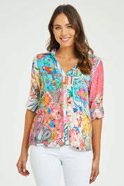 Model Madeline wearing size S of the Velma Shirt in colour Multi (Blue), from the front, cropped image