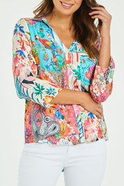 Model Madeline wearing size S of the Velma Shirt in colour Multi (Blue), from the front, cropped image