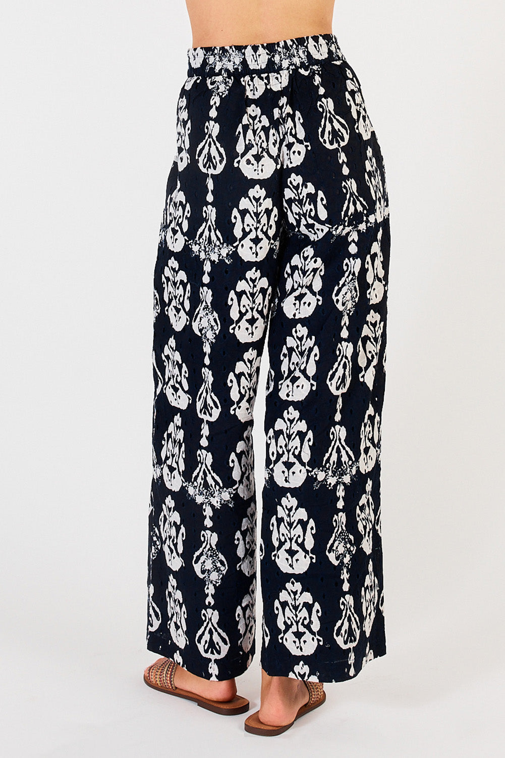 A model wearing the Verona Cotton Broderie Pant in colour Navy (Blue), from the back