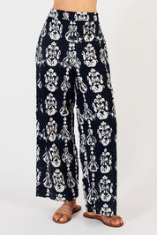 A model wearing the Verona Cotton Broderie Pant in colour Navy (Blue), from the front, cropped image